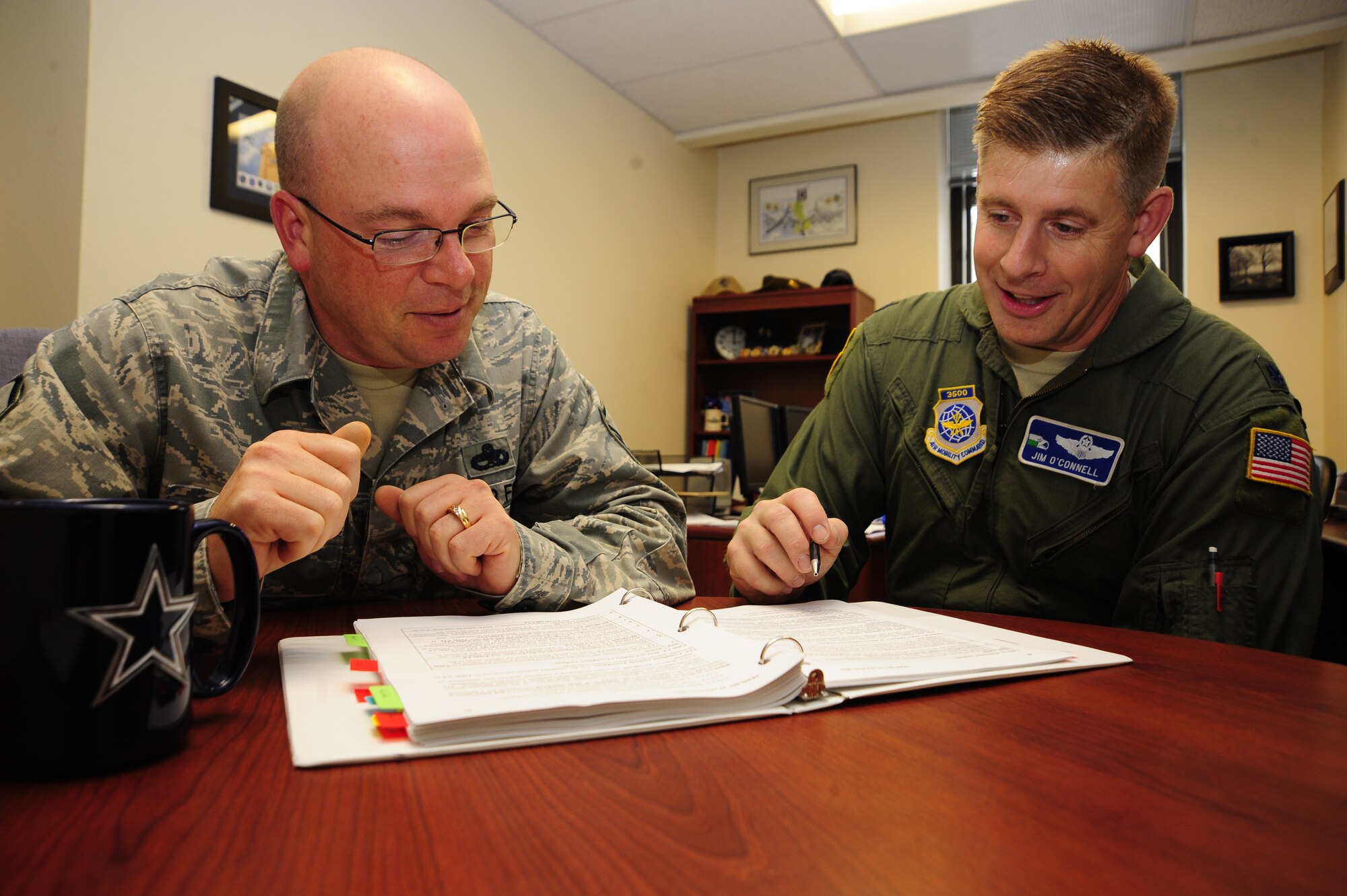Master Sgt. Terry Knight and Lt. Col. Jim O’Connell, 92nd Air Refueling Wing Inspector General’s office review some paperwork here Tuesday. The IG is here to help Fairchild Airmen. (U.S. Air Force photo/Airman 1st Class Taylor Curry)