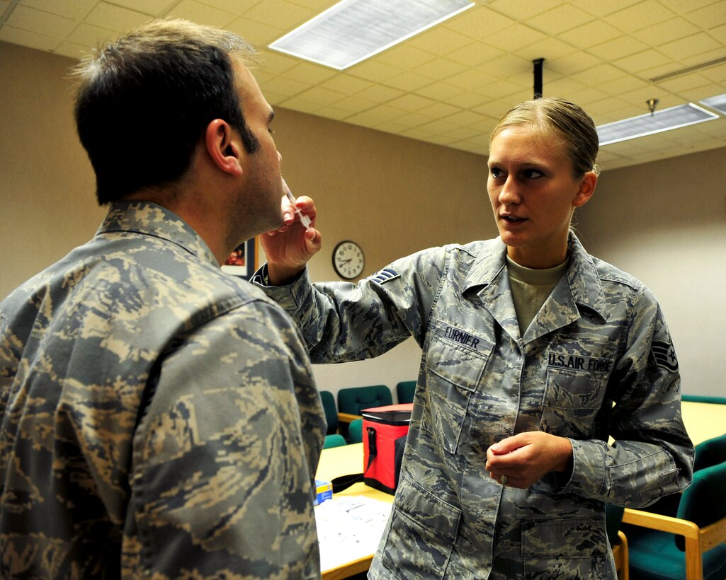 Staff Sgt. Ruth Furnier, 28th Medical Operations Squadron aerospace medical service craftsman, administers a flu vaccine to Maj. Heath Frye, 28th Communications Squadron commander, on Ellsworth Air Force Base, S.D., Sept. 28, 2011. Flu vaccines are currently only available to active-duty members and essential personnel due to limited supplies. (U.S. Air Force photo by Airman Alystria Maurer/Released)