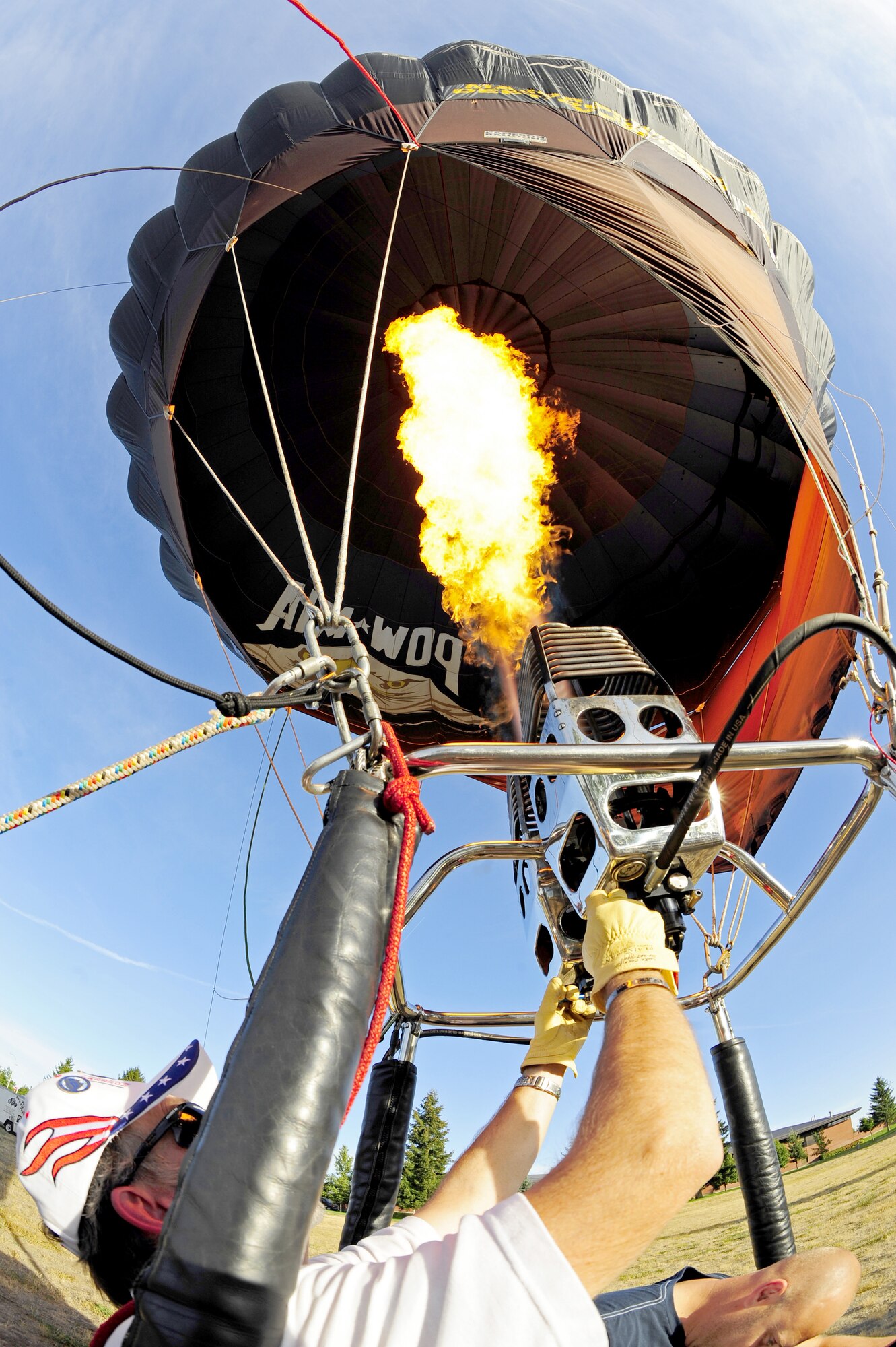 A member of the POW/MIA Hot Air Balloon Team fires up his hot air balloon in preparation for take off at Fairchild Sept. 21. (U.S. Air Force photos/Airman 1st Class Taylor Curry)