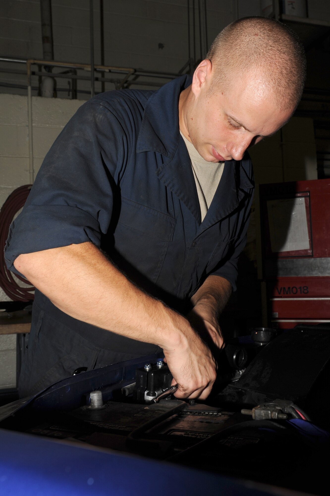 Senior Airman Brian Ball tightens a bolt on a shroud during maintenance repair at Seymour Johnson Air Force Base, N.C., Sept. 27, 2011. A shroud helps direct air through a radiator so it cools. Ball is a 4th Logistics Readiness Squadron vehicle mechanic technician and a native of Carning, N.Y.  (U.S. Air Force photo by Senior Airman Whitney Stanfield)