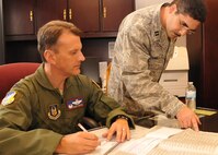 Col. Randy Ogden (left), 916th Air Refueling Wing commander, works with Capt. David Ramirez to fill out his Combined Federal Campaign pledge. Capt. Ramirez is the overall point of contact for the 916th ARW. Open solicitation ends Oct. 14, 2011. (USAF photo by SrA Meredith Thomas, 916ARW/PA)