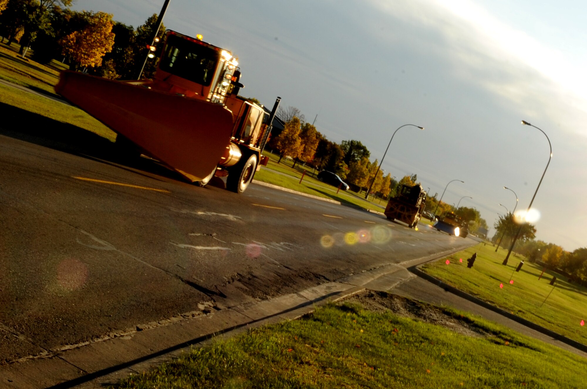Snow removal equipment vehicles cruise along during the Snow Removal Equipment Parade on Grand Forks Air Force Base Sept. 29. This year there were 18 snow removal equipment vehicles that participated in the parade which allowed base personnel to see the equipment before the first snow fall. (U.S. Air Force photo by Senior Airman Amanda N. Stencil)