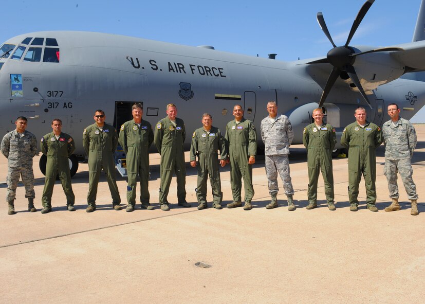 The crew of the new C-130J gathers outside the aircraft, Sept. 28, 2011, at Dyess Air Force Base, Texas. The aircraft is the eighth of 28 to be delivered to Dyess by 2013, replacing the current aging fleet of the C-130 H model. (U.S. Air Force photo by Airman 1st Class Cierra Bullock/Released)