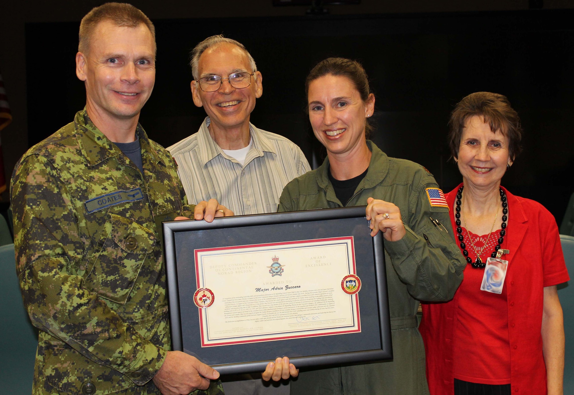 Brig. Gen. Christopher Coates, Continental U.S. North American Aerospace Defense Command Region deputy commander, presents the CONR Deputy Commander Award of Excellence to Maj. Adria Zuccaro, chief of the 601st Air and Space Operations Center’s Air Refueling Control Team, Sept. 28 for her work during the 2010 Vancouver Winter Olympics and the G20 Toronto Summit. Zuccaro’s parents, Fred and Terry Page, attended the award presentation, which marked the first time American military members have received the award. (U.S. Air Force photo by Angela Pope) 