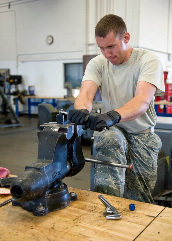 Staff Sgt. Carl Hunter, 28th Maintenance Group aerospace ground equipment craftsman, rebuilds flow control valves for a hydraulic aircraft jack at the AGE shop on Ellsworth Air Force Base, S.D., Sept. 28, 2011. The control valve limits the amount of hydraulic fluid leaving the jack’s hydraulic cylinder, thus regulating how quickly or slowly an aircraft is lowered after maintenance. (U.S. Air Force photo by Airman 1st Class Kate Thornton/Released)