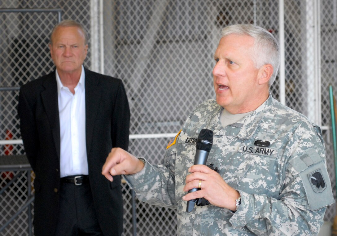 Maj Gen Myles Deering, Adjutant General for the state of Oklahoma, introduces former University of Oklahoma football coach, Barry Switzer, before speaking to deploying airmen and their families at the 138th Fighter Wing, Oklahoma Air National Guard Base in Tulsa, OK.  Members of the 138th Fighter Wing will deploy to Southwest Asia on Wednesday, 28 September 2011 in support of Operation New Dawn.  (U.S. Air Force Photo by:  Master Sergeant Preston Chasteen)