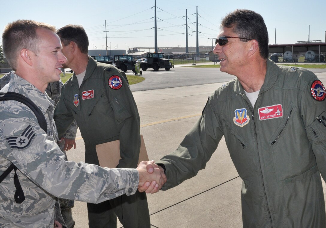 Brigadier General Michael Hepner, Commander of the 138th Fighter Wing, says good bye and shakes the hands of his airmen as they board an aircraft for deployment from the Oklahoma Air National Guard Base in Tulsa, OK.  Members of the 138th Fighter Wing will deploy to Southwest Asia on Wednesday, 28 September 2011 in support of Operation New Dawn.   (U.S. Air Force Photo by:  Master Sergeant Preston Chasteen)