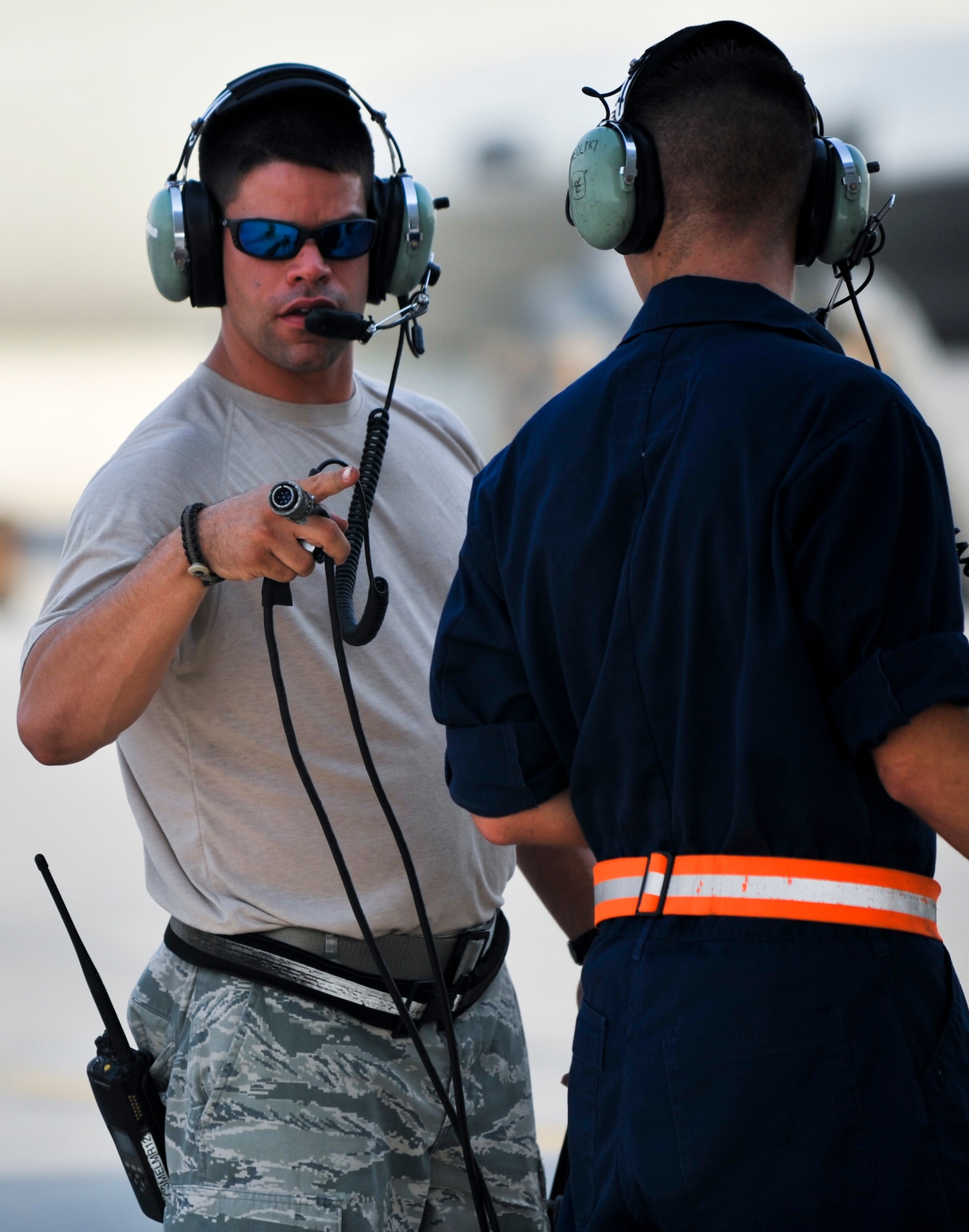Staff Sgt. Chris Knuycky (left), 7th Expeditionary Aircraft Maintenance Unit crew chief, communicates with Senior Airman Joshua Beacom, 7th EAMU crew chief, during a post flight check on an E-8C Joint Surveillance Target Attack Radar System, or Joint STARS, aircraft, Sept. 25, 2011, at an undisclosed location in Southwest Asia. Knuycky, a native of Winder, Ga., and Beacom, a native of Jacksonville, Fla., are both deployed from Robins Air Force Base, Ga. (U.S. Air Force photo/Senior Airman Paul Labbe)