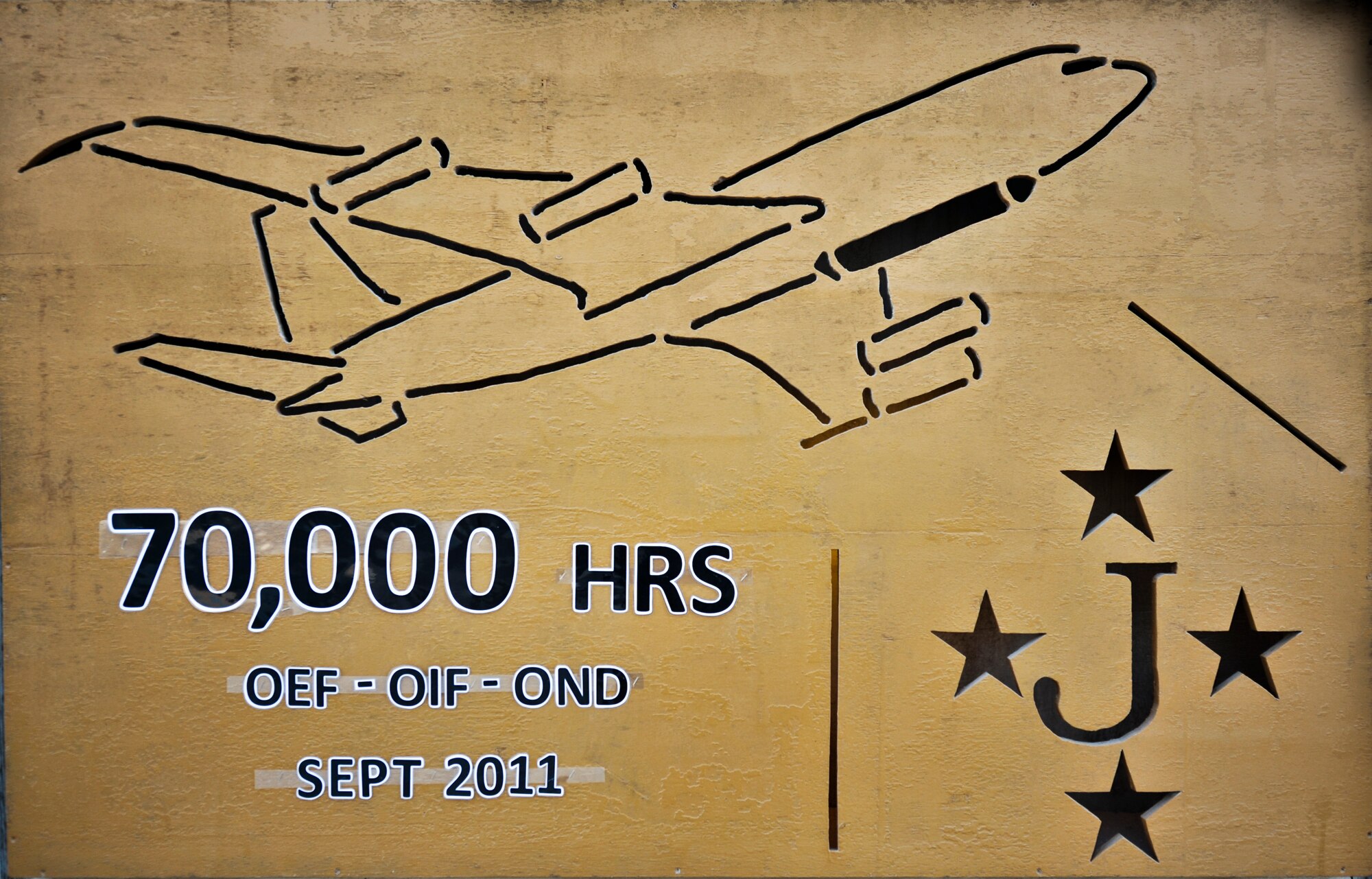 A concrete barrier wall in front of the 7th Expeditionary Airborne Command and Control Squadron operations building at an undisclosed location in Southwest Asia was painted to commemorate 70,000 flight hours in the U.S. Central Command Area of Responsibility for the 116th Air Control Wing, Robins AFB, Ga., in the E-8C Joint Surveillance Target Attack Radar System, or Joint STARS.  The wing has flown an average of 19 hours each day since Sept. 11, 2001, or the equivalent of being airborne for eight years.  (U.S. Air Force photo/Senior Airman Paul Labbe