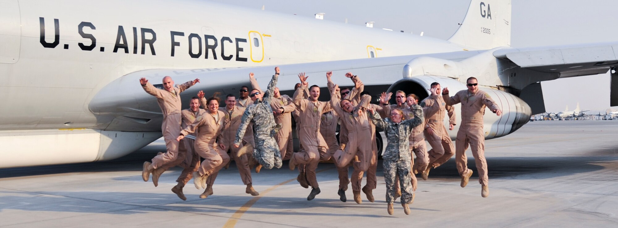 A crew from the 7th Expeditionary Airborne Command and Control Squadron celebrate after completing a sortie that marked 70,000 flight hours in the U.S. Central Command Area of Responsibility for the 116th Air Control Wing, Robins AFB, Ga., in the E-8C Joint Surveillance Target Attack Radar System, or Joint STARS, Sept. 25, 2011, at an undisclosed location in Southwest Asia. The wing has flown an average of 19 hours each day since Sept. 11, 2001, or the equivalent of being airborne for eight years.  (U.S. Air Force photo/Senior Airman Paul Labbe)
