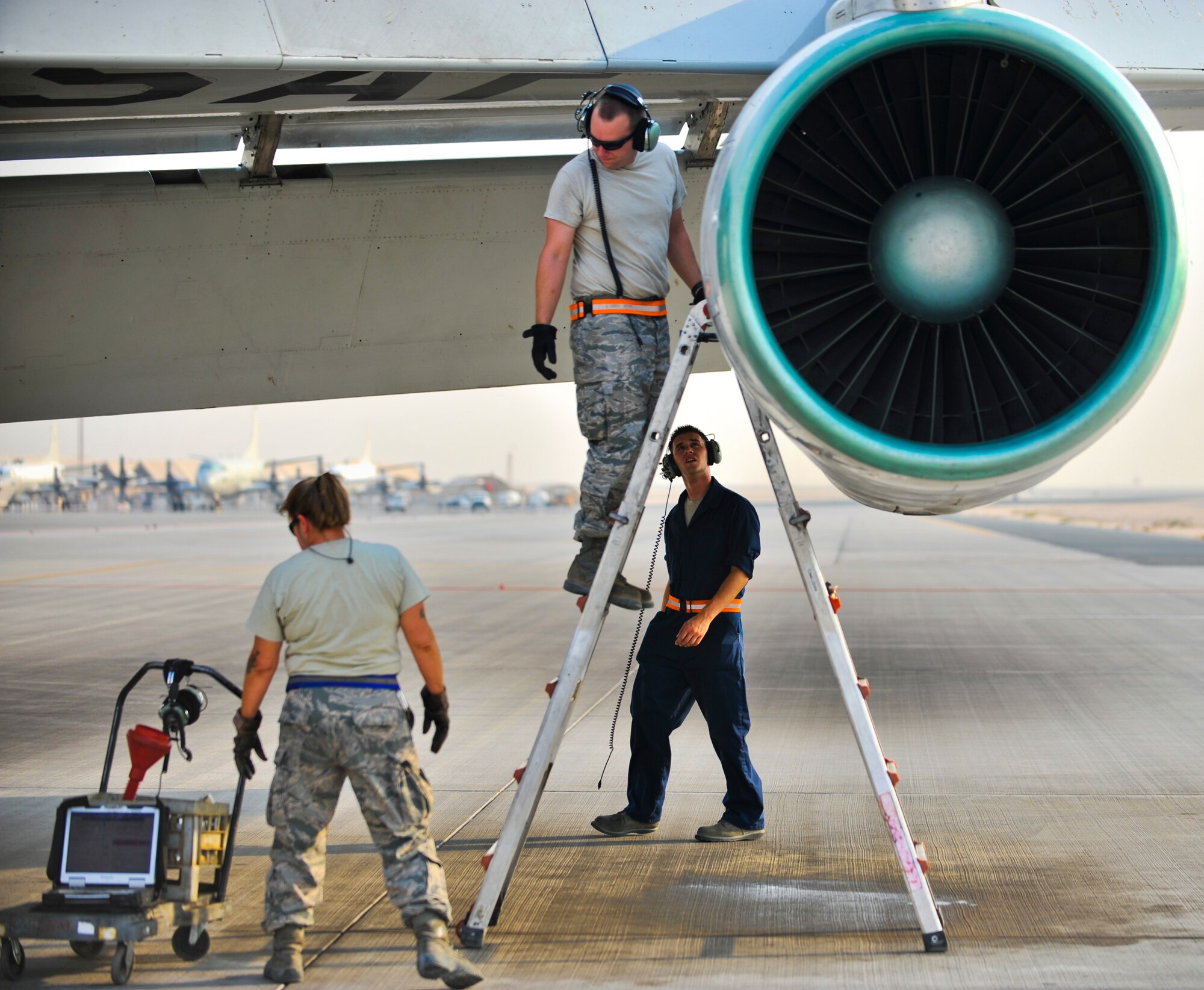 Master Sgt. Cheryl Moore, Staff Sgt. Brian Nash and Senior Airman Joshua Beacom, all from the 7th Expeditionary Aircraft Maintenance Unit, perform a post flight inspection on an E-8C Joint Surveillance Target Attack Radar System, or Joint STARS aircraft, Sept. 25, 2011, at an undisclosed location in Southwest Asia. All three Airmen are deployed from Robins Air Force Base, Ga.  Moore is a native of Byron, Ga., while Nash hails from Dover, N.H., and Beacom from Jacksonville, Fla.