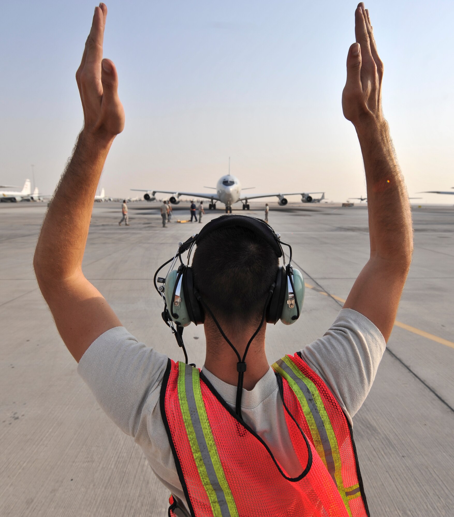 Airman 1st Class Paul Hage, 7th Expeditionary Aircraft Maintenance Unit crew chief, marshals an E-8C Joint Surveillance Target Attack Radar System, or Joint STARS, aircraft into position Sept. 25, 2011, at an undisclosed location in Southwest Asia. The sortie marked 70,000 flight hours for the Joint STARS in the U.S. Central Command Area of Responsibility since Sept. 11, 2001. Hage, a native of Pompano Beach, Fla., is deployed from Robins Air Force Base, Ga. (U.S. Air Force photo/Senior Airman Paul Labbe)