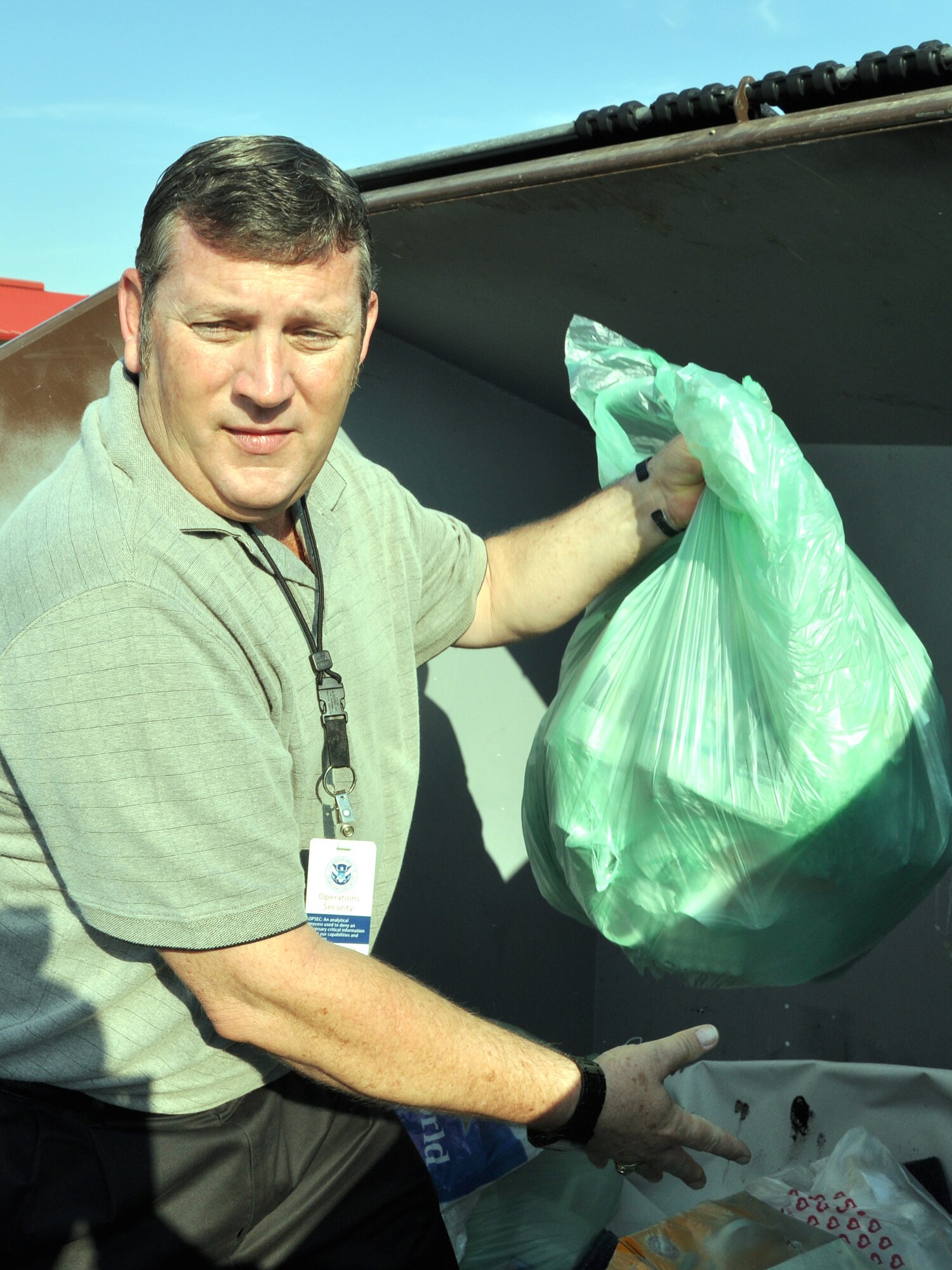 RANDOLPH AIR FORCE BASE, Texas – Dr. Jim Crissinger, Air Education and Training Command program manager for critical asset risk management and operations security programs, pulls a bag of trash from a dumpster on base to be inspected for operations security violations Sept. 28. Crissinger and his team have increased inspection efforts to mitigate security concern across AETC. (U.S. Air Force photo/Staff Sgt. Clinton Atkins)