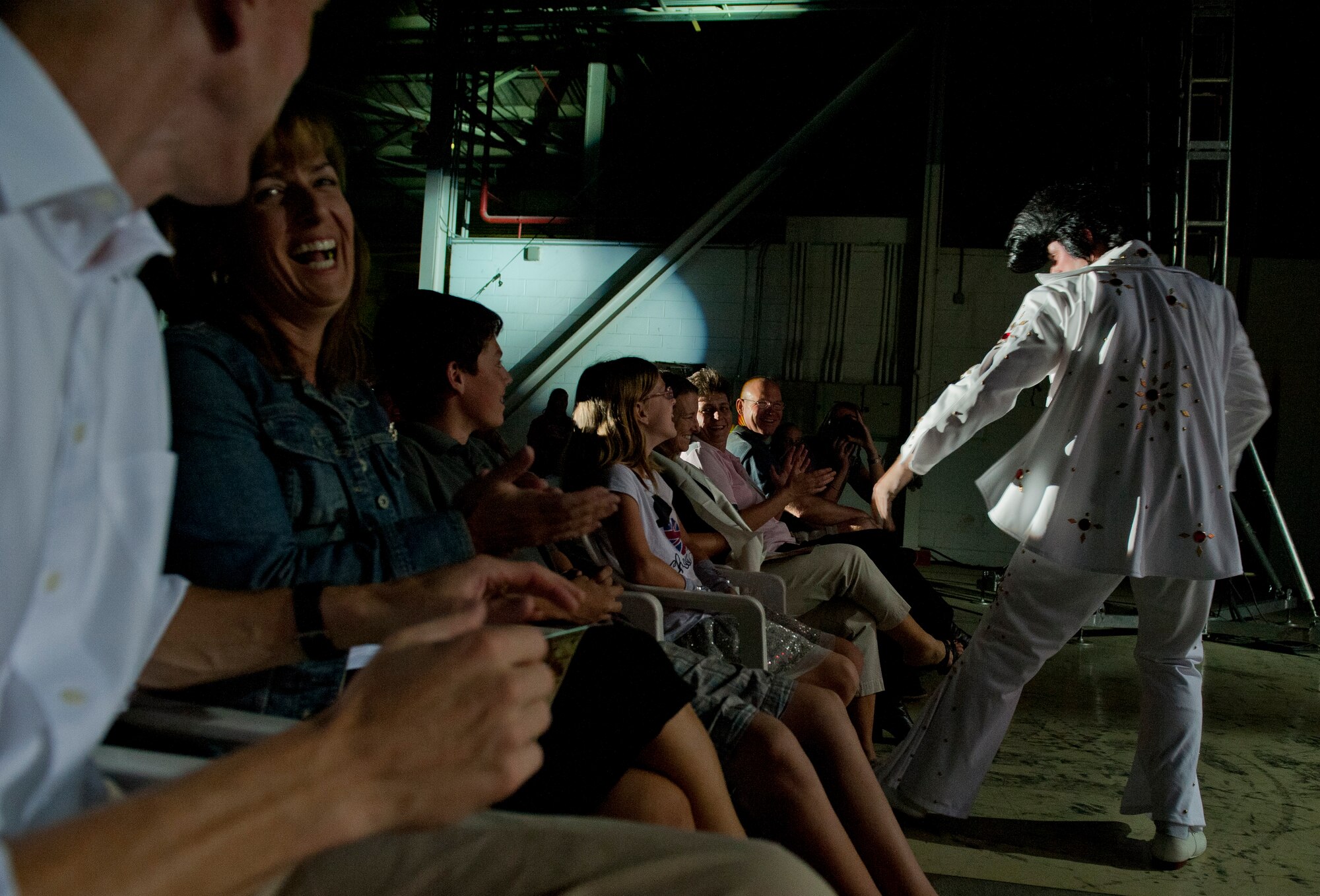 Senior Airman Cordero Nichols, Tops in Blue vocalist, impersonates Elvis Presley as he serenades front-row audience members during a performance Sept. 27, 2011, at Incirlik Air Base, Turkey. Tops in Blue serves as an expeditionary entertainment unit that provides quality entertainment from within Air Force resources for the Air Force family. The group promotes community relations, supports recruiting efforts, and serves as ambassadors for the U.S. and the Air Force. (U.S. Air Force photo by Senior Airman Anthony Sanchelli/Released)