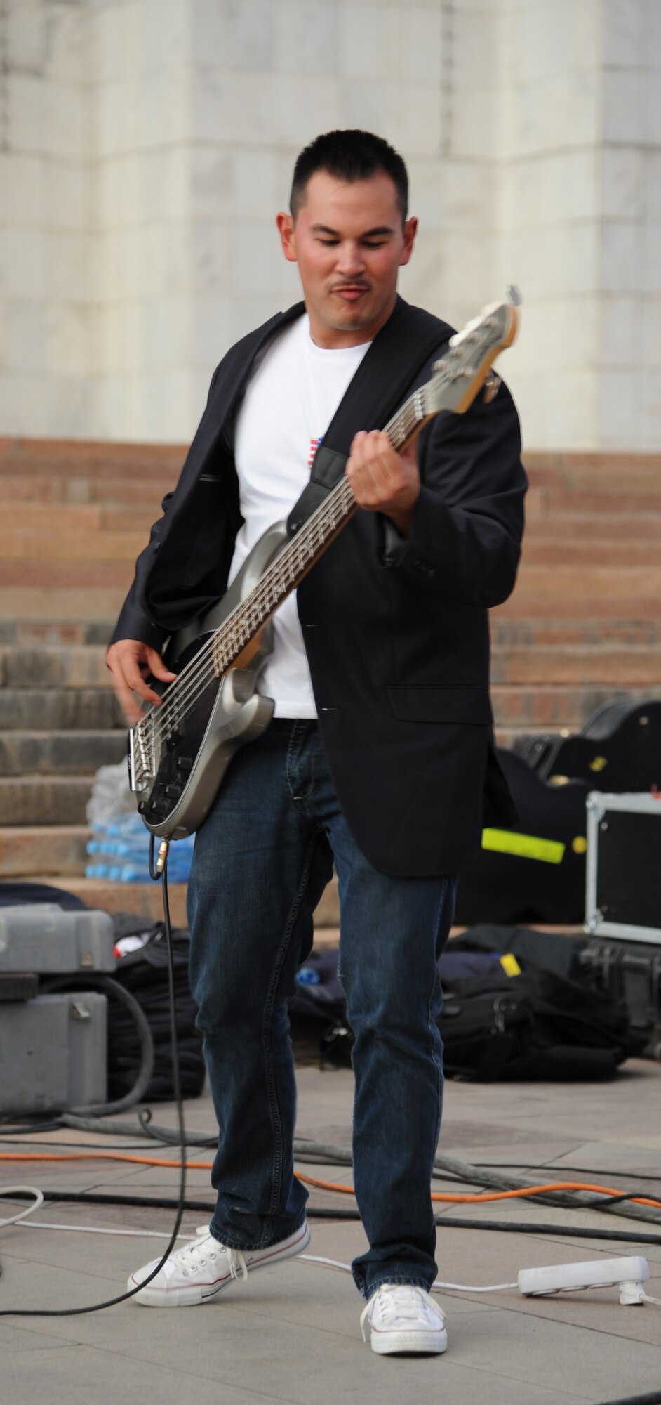 Airman 1st Class Phil Runge plays bass guitar during a “Top Cover” performance at A’la Too Square in Bishkek, Kyrgyzstan, Sept. 23. Top Cover is a seven-member U.S. Air Forces Central Command band performing throughout the area of responsibility to build troop morale and public diplomacy. Runge is deployed from Joint Base Elmendorf-Richardson, Alaska. He is a native of Chicago. (U.S. Air Force photo/Tech. Sgt. Hank Hoegen)
