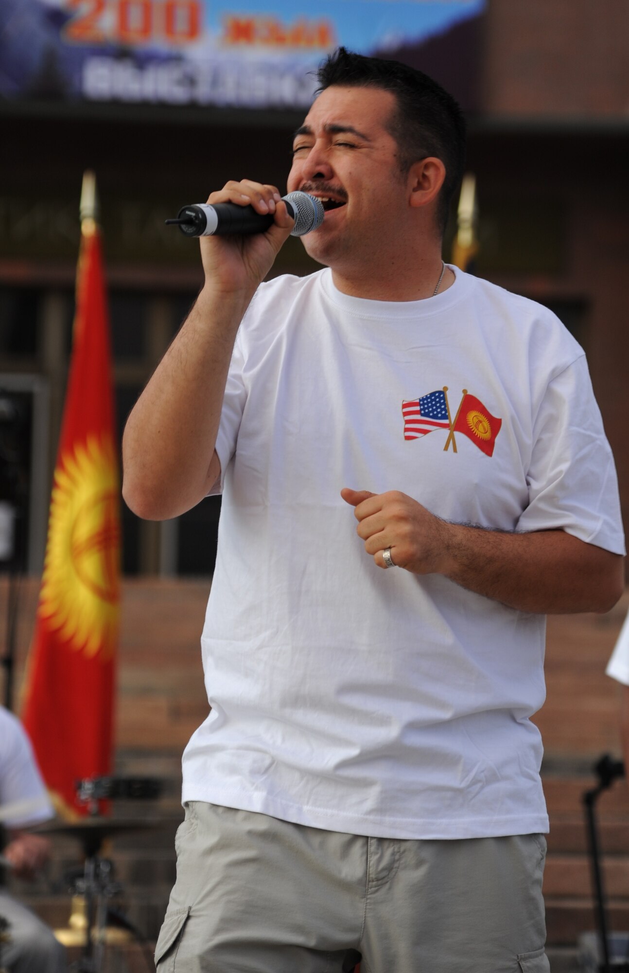 Staff Sgt. Justin Allen sings during a “Top Cover” performance at A’la Too Square in Bishkek, Kyrgyzstan, Sept. 23. The first stop on the U.S. Air Forces Central Command band Top Cover’s tour of seven countries was the Kyrgyz Republic where they played two shows at the Transit Center at Manas and six concerts at various locations off the installation. Allen is a vocalist deployed from Joint Base Elmendorf-Richardson, Alaska. (U.S. Air Force photo/Tech. Sgt. Hank Hoegen)