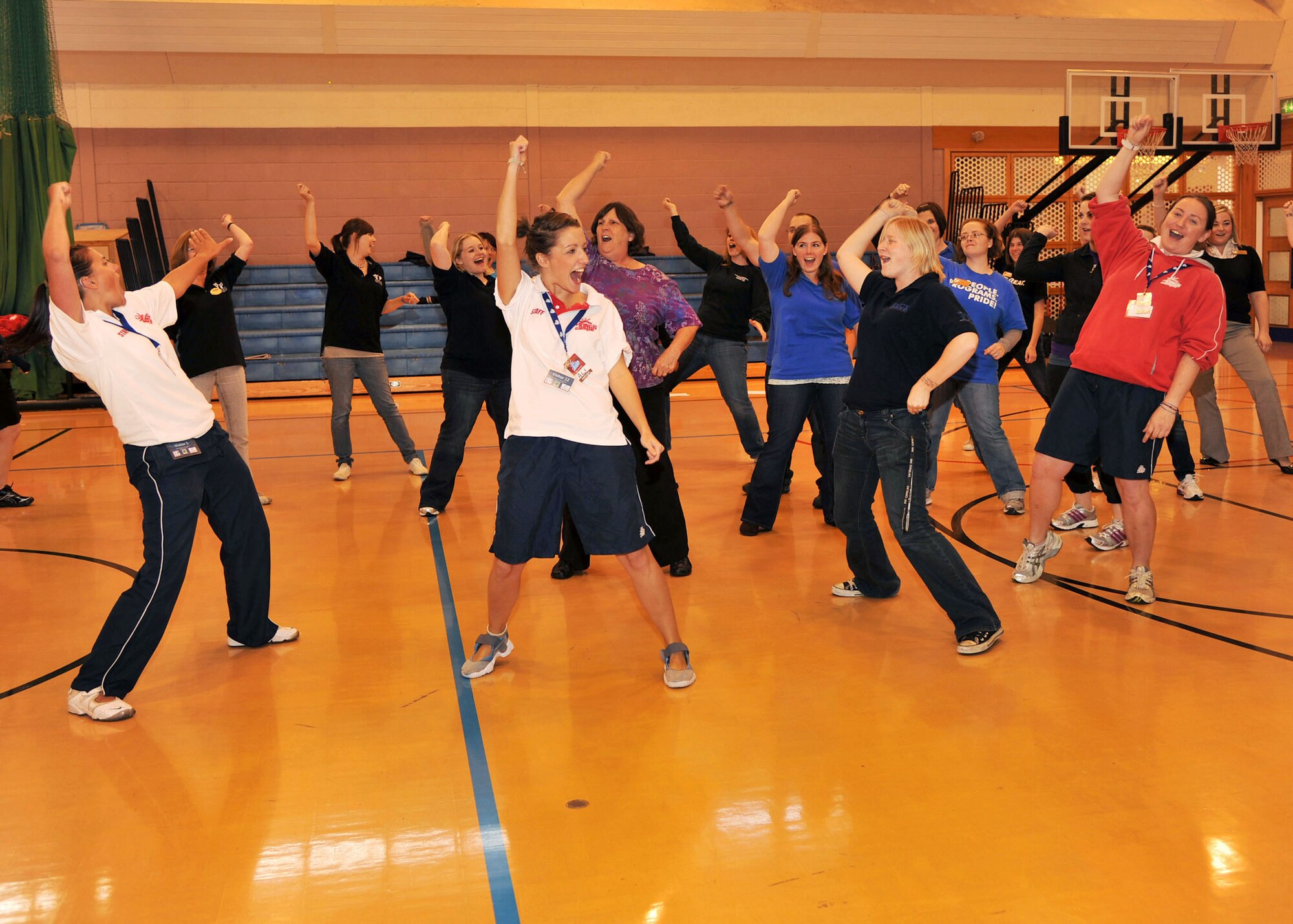 RAF MILDENHALL, England - Youth center staff members from RAFs Mildenhall, Lakenheath and Croughton join the King’s Foundation staff in a dance activity here Sept. 22, 2011. The King’s Foundation visited the bases for a three-day training camp where they worked to come up with new and unique ways to interact with children. (U.S. Air Force photo by Senior Airman Jerilyn Quintanilla)