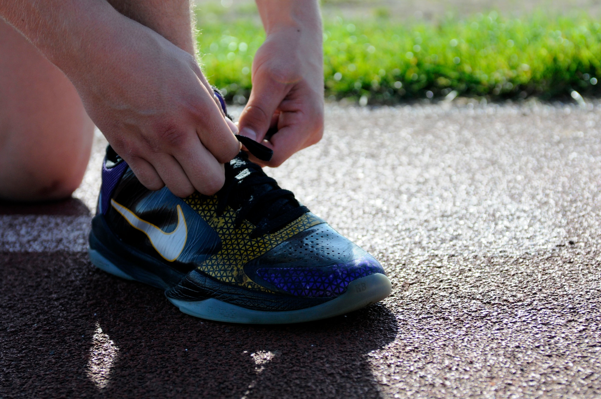 SPANGDAHLEM AIR BASE, Germany -- Airman 1st Class Ryan Jelstrom, 480th Fighter Squadron flight equipment maintainer, laces up for a run around the track Sept. 27 at the Skelton Memorial Fitness Center.  Jelstrom was selected to run with the U.S. Air Forces in Europe running team in the U.S. Air Force Marathon’s half marathon Sept. 17. He placed 59 out of approximately 6,600 racers with a time of 01:28:00. (U. S. Air Force photo/Senior Airman Natasha Stannard)