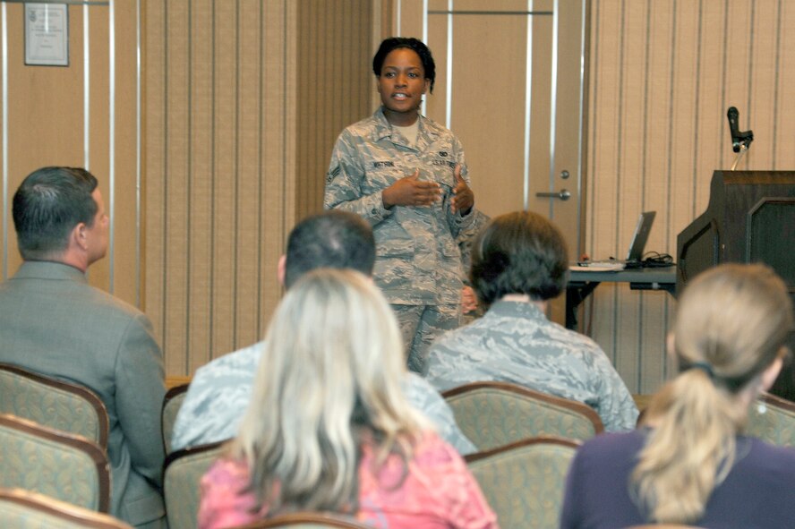 MISAWA AIR BASE, Japan - Senior Airman Reshelle Watson, 35th Security Forces Squadron, briefs military dependents during a simulated town hall meeting here Sept. 29. The simulation was part of an exercise testing the wing's ability to deploy its forces. A cross-section of base agencies briefed military dependents and answered their questions regarding the simulated deployment and what services will be available to sustain and assist them in the event their loved ones deploy. (U.S. Air Force photo/Tech. Sgt. Marie Brown)
