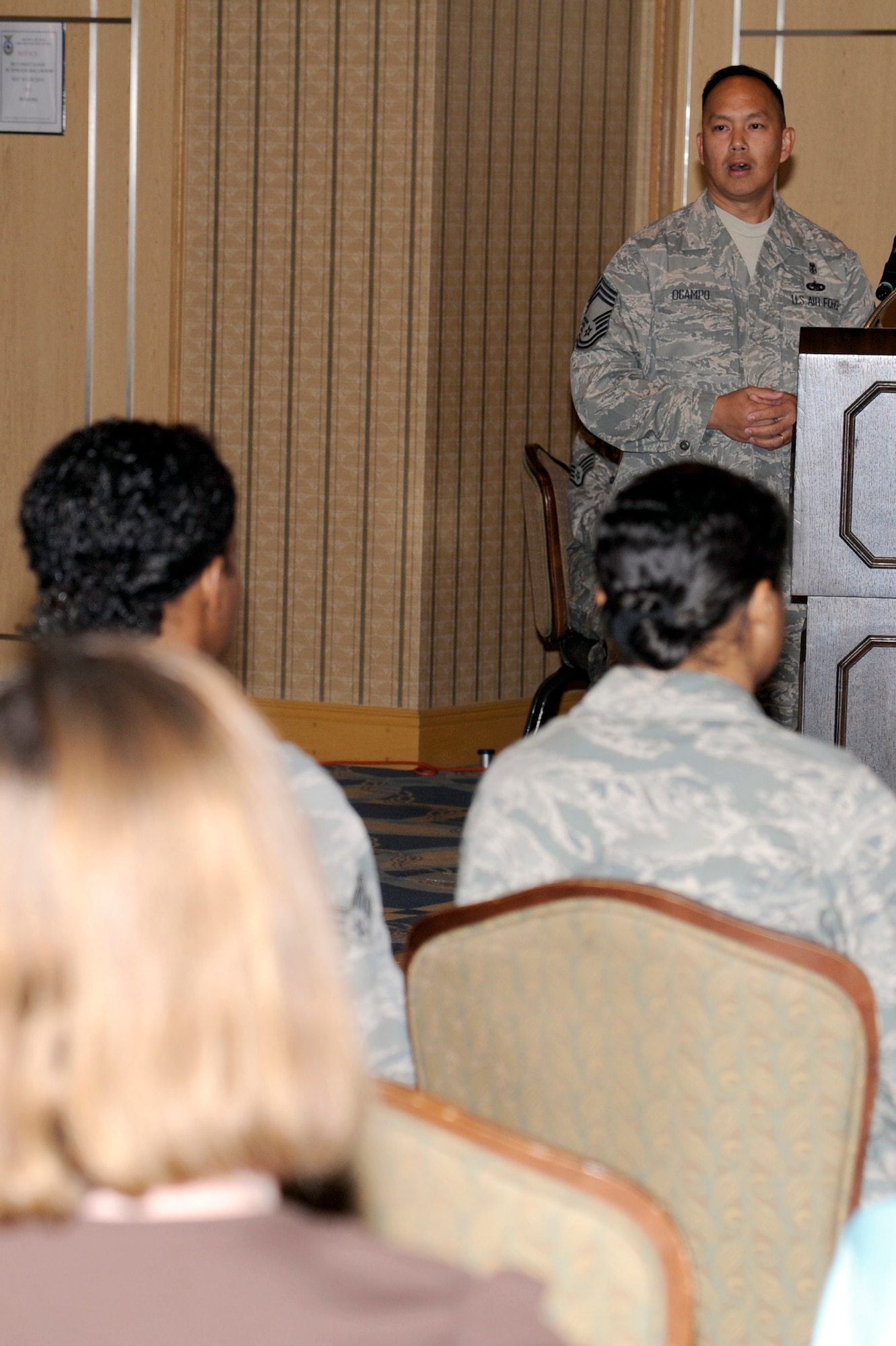 MISAWA AIR BASE, Japan - Chief Master Sgt. Clifford Ocampo gives opening remarks at a simulated town hall meeting here Sept. 29. The simulation was part of an exercise testing the wing's ability to deploy its forces. A cross-section of base agencies briefed military dependents and answered their questions regarding the simulated deployment and what services will be available to sustain and assist them in the event their loved ones deploy. (U.S. Air Force photo/Tech. Sgt. Marie Brown)
