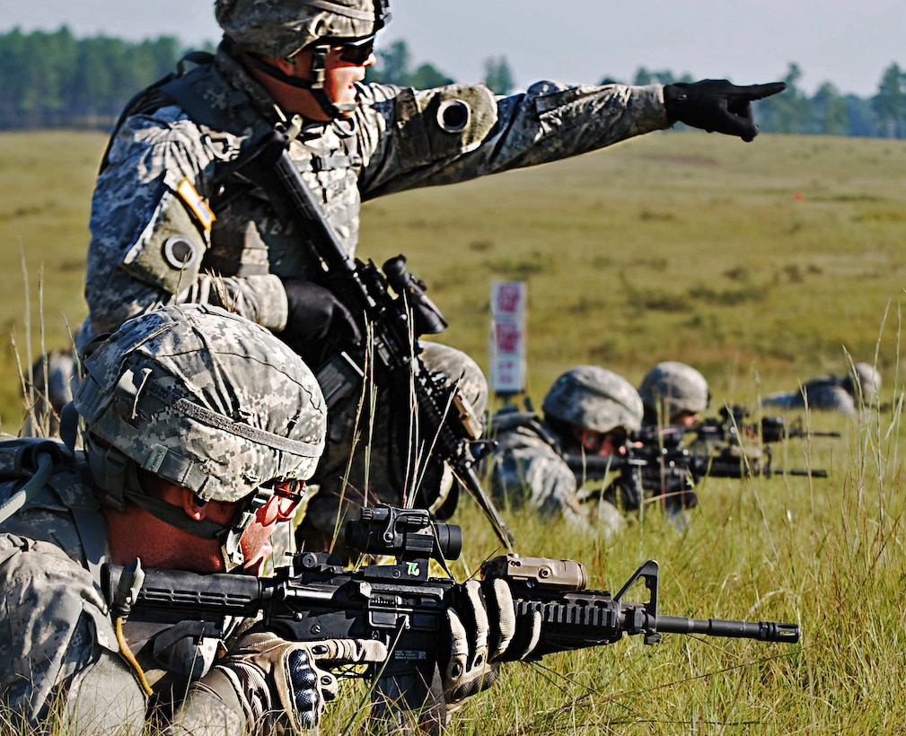 U.S. Army Pvt. Gunner M. Whitaker receives firing instructions from squad leader Sgt. Diego De La Vega during live-fire training at Camp Shelby Joint Forces Training Center, Miss., Sept. 25, 2011. De La Vega and his squad are firing live rounds during squad movements to prepare for potential combat during their upcoming deployment to Afghanistan. Whitaker and De La Vega are assigned to A Company, 1st Battalion, 148th Infantry Regiment, 37th Infantry Brigade Combat Team.