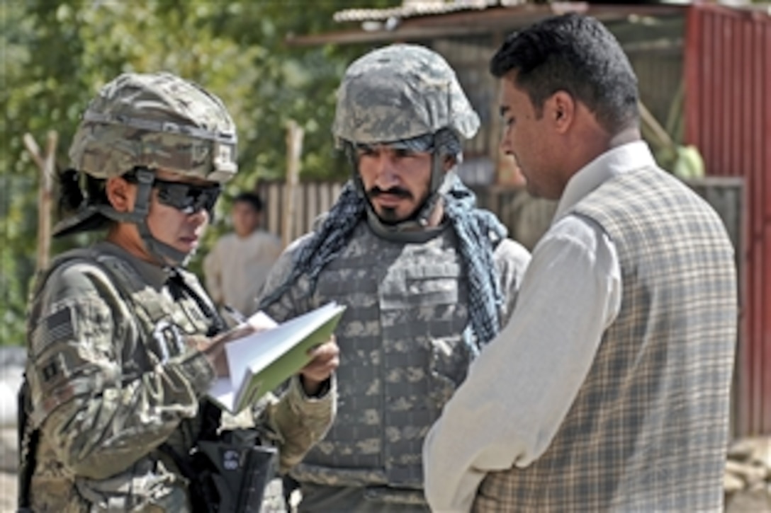 U.S. Air Force Capt. Sigan Wilson conducts a construction quality assurance mission of the eight-mile Dara Puta Road project, which connects several villages in the Nejrab district in Afghanistan's Kapisa province, Sept. 24, 2011. Wilson is a Kapisa Provincial Reconstruction Team civil engineer. 
