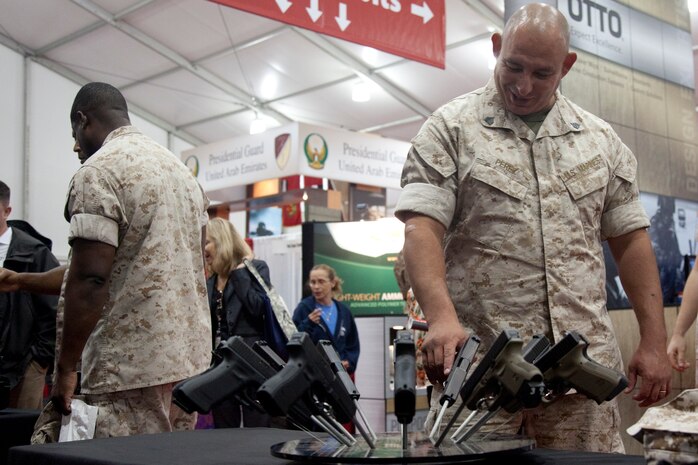 A Marine checks out the latest pistol technology at the GLOCK display during the Modern Day Marine Military Exposition at Marine Corps Base Quantico, Va., Sept. 29. Although many of the products were not currently in use by the Corps, the exposition gave vendors the opportunity to promote their products to Marines.