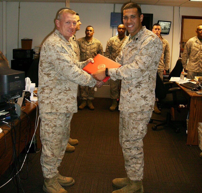 LtCol Owen congratulates Sgt Oscar Solis during his reenlistment ceremony.