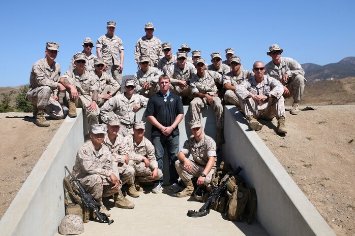 Marines with 1st Reconnaissance Battalion, 1st Marine Division, pose with Sgt. Dakota Meyer, Medal of Honor recipient, at Range 218, Sept. 27. Meyer visited with Marines from multiple units across Camp Pendleton in his final tour before returning home. ::r::::n::::r::::n::::r::::n::