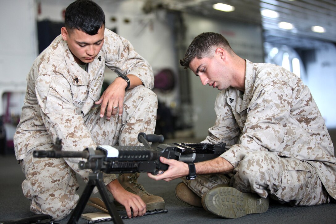 Cpl. Steve R. Vargas, a 22-year-old from Midland, Texas, and Cpl. James C. Nelson, a 23-year-old from East Liverpool, Ohio, both with Military Police Company, Combat Logistics Regiment 17, put together an M240 machine gun during Exercise Dawn Blitz, aboard the USS Bonhomme Richard, Sept. 29. “We’re here to give Marines their sea legs and show them ship life,” said Capt. Kyle E. Larish, the MP company commander. “We are giving them that experience because most of them have never been on a ship. So in the future if they do go aboard a ship for a deployment they are already used to it.  They know what they can and can’t do on a ship and the spaces they can train in.”