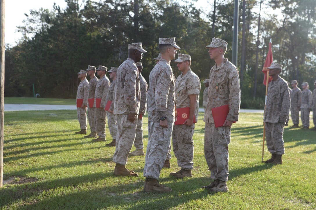 Lt. Col. Leland Suttee, commanding officer for 2nd Air Naval Gunfire Liaison Company, II Marine Expeditionary Force Headquarters Group, II Marine Expeditionary Force, talks to one of the nine Marines who were awarded a variety of medals during an awards ceremony aboard Marine Corps Base Camp Lejeune, Sept. 30.