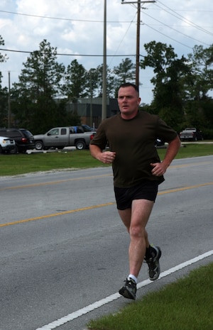 Gunnery Sgt. James J. Dacey, company gunnery sergeant for Support Company, 8th Engineer Support Battalion, 2nd Marine Logistics Group, runs aboard Camp Lejeune, N.C., September 28, 2011. Dacey regularly runs atleast nine miles to practice for his 345-mile run from Camp Lejeune the National Naval Medical Center, Bethesda, Md., in honor of wounded warriors beginning October 22, 2011. (U.S. Marine Corps photo by Pfc. Franklin E. Mercado)