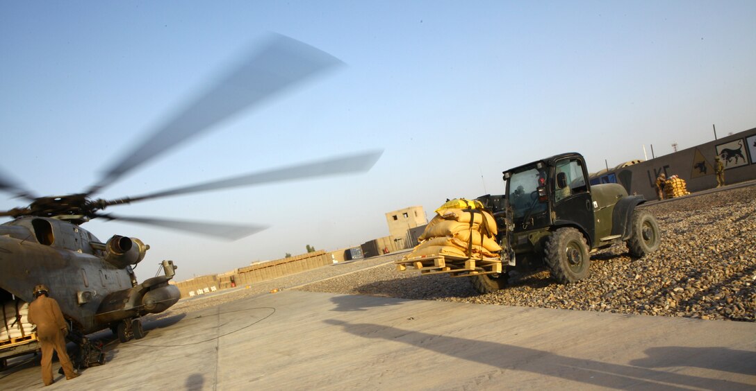 Pallts of vegetable seed are loaded onto aircraft to be transported from Lashkar Gah, Afghanistan, to Kajaki, Sept. 30, 2011, as part of a Helmand province program to reduce the drug trade and increase stabilization and security in the area.  The program has been in place for four years, distributing wheat and vegetable seed and fertilizer to more than 40,000 farmers in 11 districts.  (U.S. Marine Corps photo by Cpl. Katherine M. Solano)