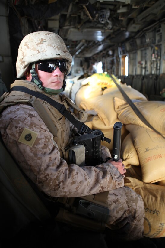 Staff Sgt. Jason Skaggs, a transportation coordinator with 2nd Marine Logistics Group (Forward), flies with 4 pallets of wheat and vegetable seed from Lashkar Gah, Afghanistan, to Kajaki, Sept. 30, 2011.  The seed will be distributed to local farmers over the next several weeks as part of a four-year counter-narcotic program in Helmand province.  (U.S. Marine Corps photo by Cpl. Katherine M. Solano)