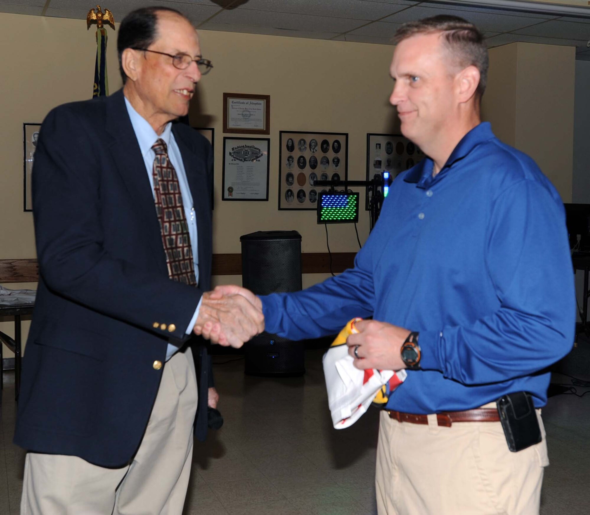 Jack Calvert, senior-vice commander of Veterans of Foreign Wars Post 112, Wichita, Kan., presents a "Welcome Home" flag to Col. William Mason, commander of the 931st Air Refueling Group, McConnell Air Force Base, Kan., during a welcome home party Sept. 30.  The VFW post hosted the party in honor of more than 80 members of the 931st who had returned from a recent overseas deployment.  (U.S. Air Force photo/1st Lt. Zach Anderson)  