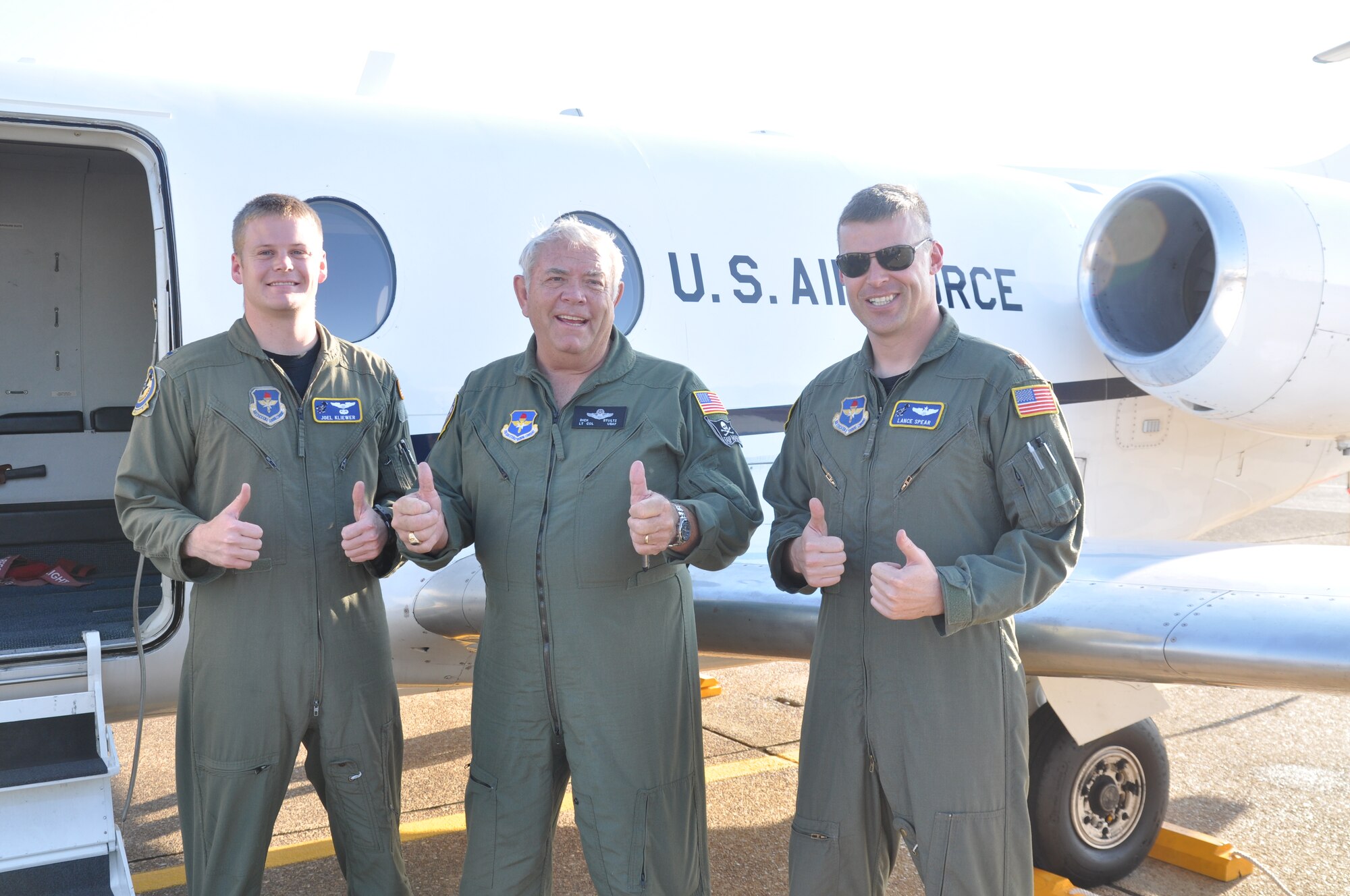 1st Lt. Joel Kliewer, 48th Flying Training Squadron, Retired Air Force Lt. Col. Dick Stultz and Maj. Lance Spear, 48th FTS, give two thumbs up after Stultz’s T-1 Jayhawk orientation flight on Sept. 30. (U.S. Air Force photo/Sonic Johnson)