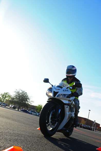 Staff Sgt. Eric Peaslee, 317th Aircraft Maintenance Squadron, completes a motorcycle safety course, Sept. 30, 2011, at Dyess Air Force Base, Texas.  The course is set up and sponsored by the Green Knights Motorcycle Club to help riders increase motorcycle safety and technique on their personal bikes. (U.S. Air Force photo by Airman 1st Class Peter Thompson/Released)