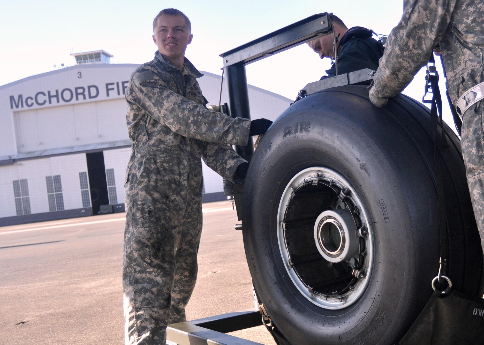 Airman 1st Class Tommy Rasmus, 62nd Aircraft Maintenance Squadron crew chief, helps to load a new tire onto a C-17 Globemaster III September 29, 2011, at Joint Base Lewis-McChord, Wash. Tires are changed every 120 days unless they become worn out early. (U.S. Air Force photo/Airman 1st Class Leah Young)