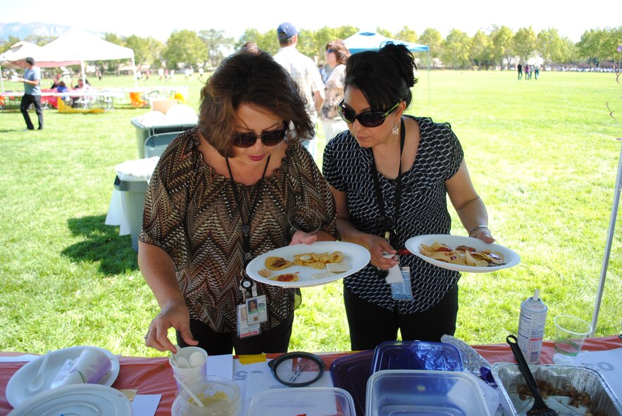Chrstine Garcia, left, and Marisela Marquez, both of Sandia National Laboratories, taste-test several Hispanic food samples.
Photo by Todd Bailey
