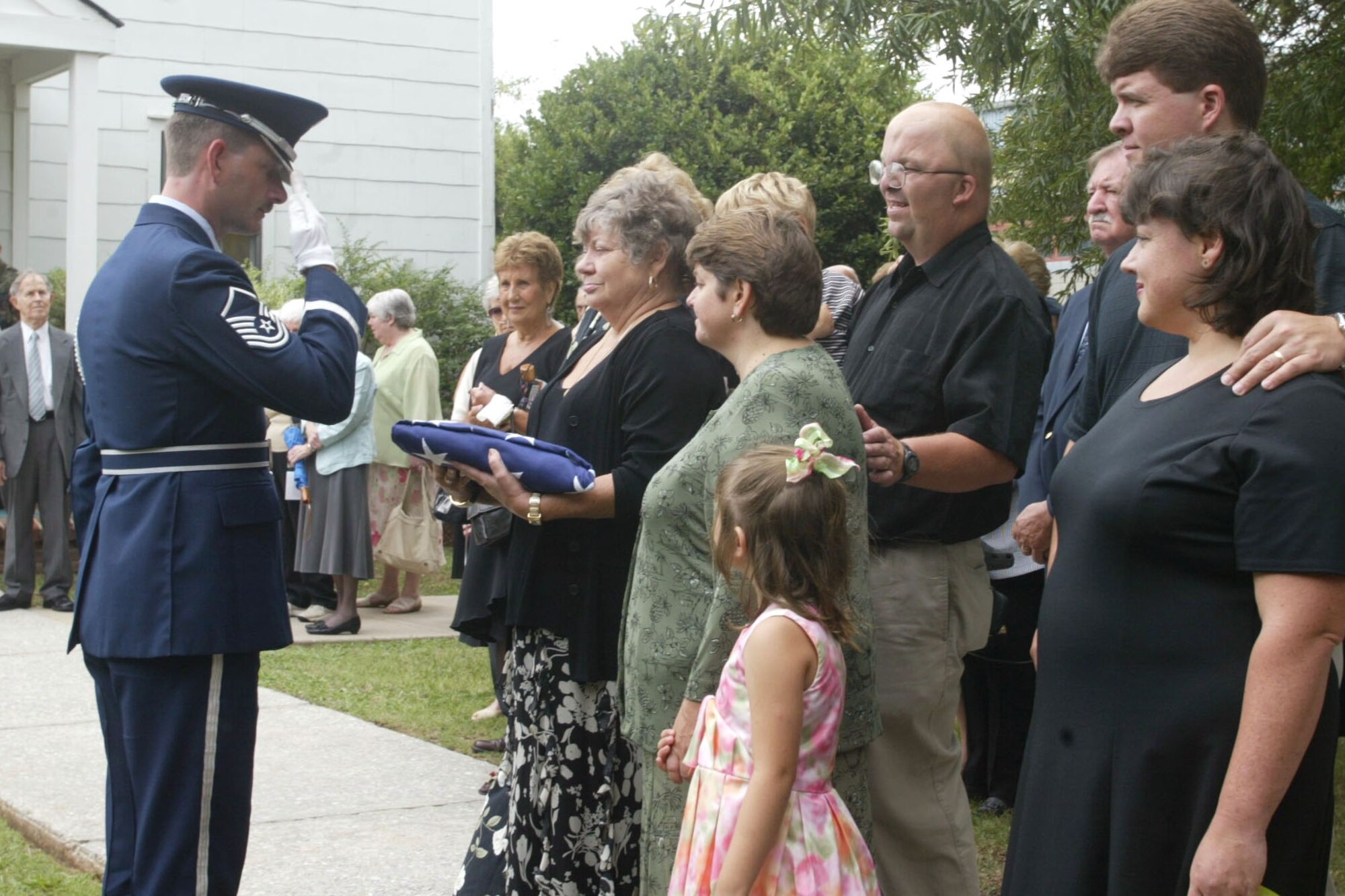 Master Sgt. Bruce See, Honor Guard Superintendant at Dobbins ARB and ceremonial guardsman, salutes the family of a deceased loved one in an honor guard ceremony. Sgt. See is retiring after 20 years of service in the United States Air Force.  From 2005 to 2011, Sgt. See held the title of Honor Guard Superintendant.  (U.S. Air Force photo/ Don Peek)
