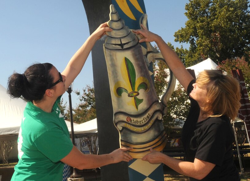 Katie Lund and Kye Quesinberry, members of the Barksdale Officers Spouses Club, hang a wooden beer stein on an archway during setup for the Oktoberfest celebration at the Barksdale Consolidated Club on Barksdale Air Force Base, La., Sept. 30. The annual celebration was started in 2007 by retired Col. West Anderson, former 2nd Bomb Wing vice commander and is the base's largest morale event. (U.S. Air Force photo/Senior Airman Kristin High)(RELEASED)
