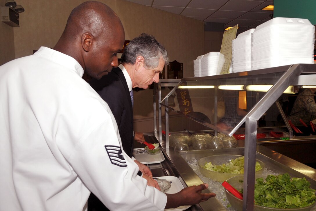 U.S. Air Force Tech. Sgt. Mitchell Scott, 633rd Force Support Squadron dining facility assistant manager, shows U.S. Rep. Scott Rigell around the Crossbow Dining Facility at Langley Air Force Base, Va., Sept. 29, 2011.  Rigell visited Langley to dine with Airmen and speak to them about issues affecting their lives.  (U.S. Air Force photo by Staff Sgt. Logan Tuttle/Released)