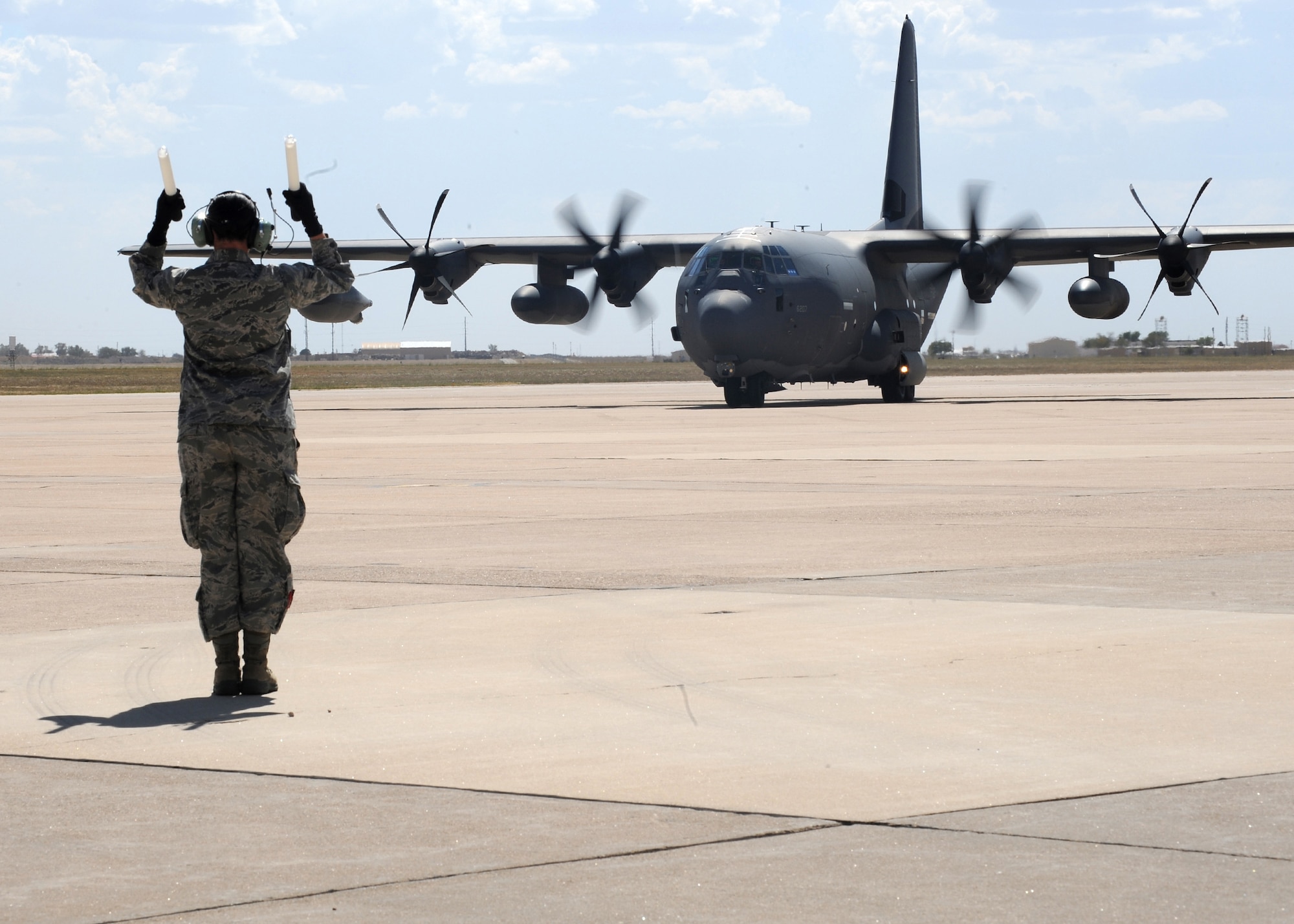 The MC-130J Combat Shadow II is marshaled into place at Cannon Air Force Base, Sept. 29, 2011. The MC-130J is the newest variant of the C-130J Super Hercules four-engine turboprop aircraft. (U.S. Air Force photo by Airman 1st Class Xavier Lockley)