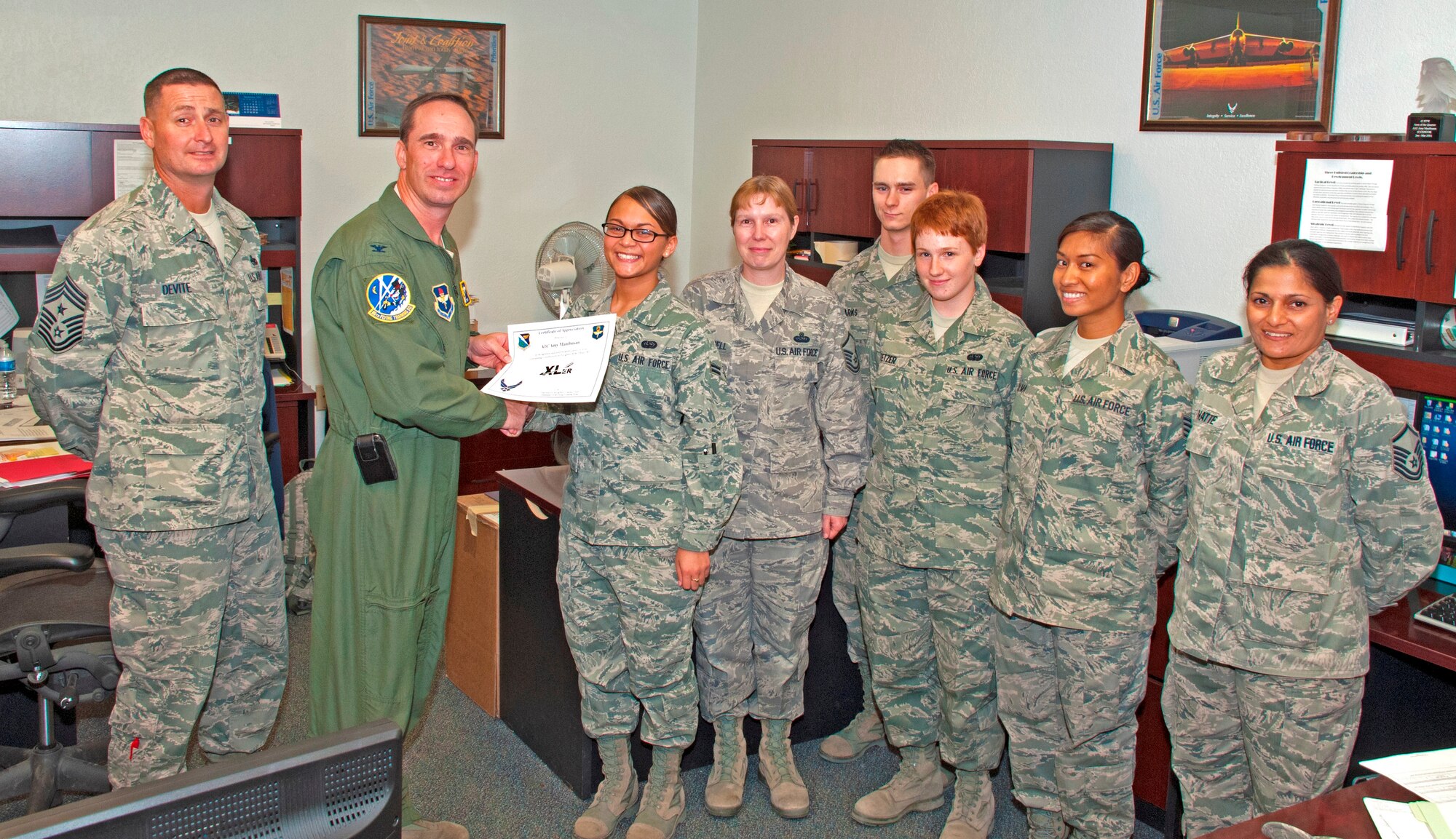LAUGHLIN AIR FORCE BASE, Texas -- Airman 1st Class Amy Manibusan, 47th Communications Squadron Knowledge Operations manager, is presented the XLer of the Week award by Col. Thomas Murphy, 47th Flying Training Wing commander, and Chief Master Sgt. Ray DeVite, 47th FTW command chief, Sept. 21 here. The XLer is a weekly award chosen by wing leadership and given to those who consistently make outstanding contributions to Laughlin and their unit. (U.S. Air Force photo/Senior Airman Scott Saldukas)