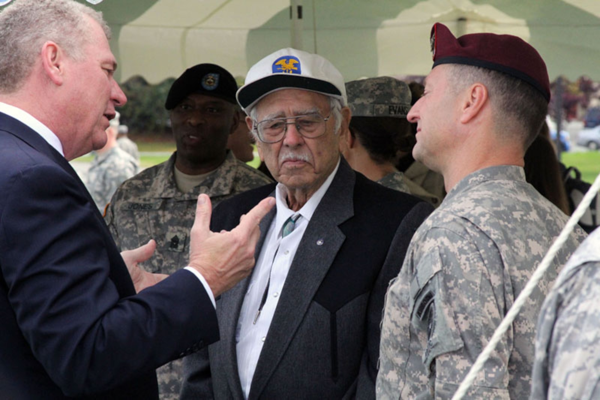 Ed Leard, grandson of a 2nd Engineer Amphibious Brigade Soldier killed in World War II, chats with World War II veteran Jack Reed and U.S. Army Alaska Commanding General, Maj. Gen. Raymond Palumbo after the 2nd Engineer Brigade’s activation ceremony, Sept. 21, at Joint Base Elmendorf-Richardson’s Pershing Field. With a rich history – including 82 combat landings with 15 different assault divisions during World War II – the 2nd Eng. Bde. activates 56 years after the unit last cased its colors.  (U.S. Army photo/2nd Engineer Brigade Public Affairs Office)