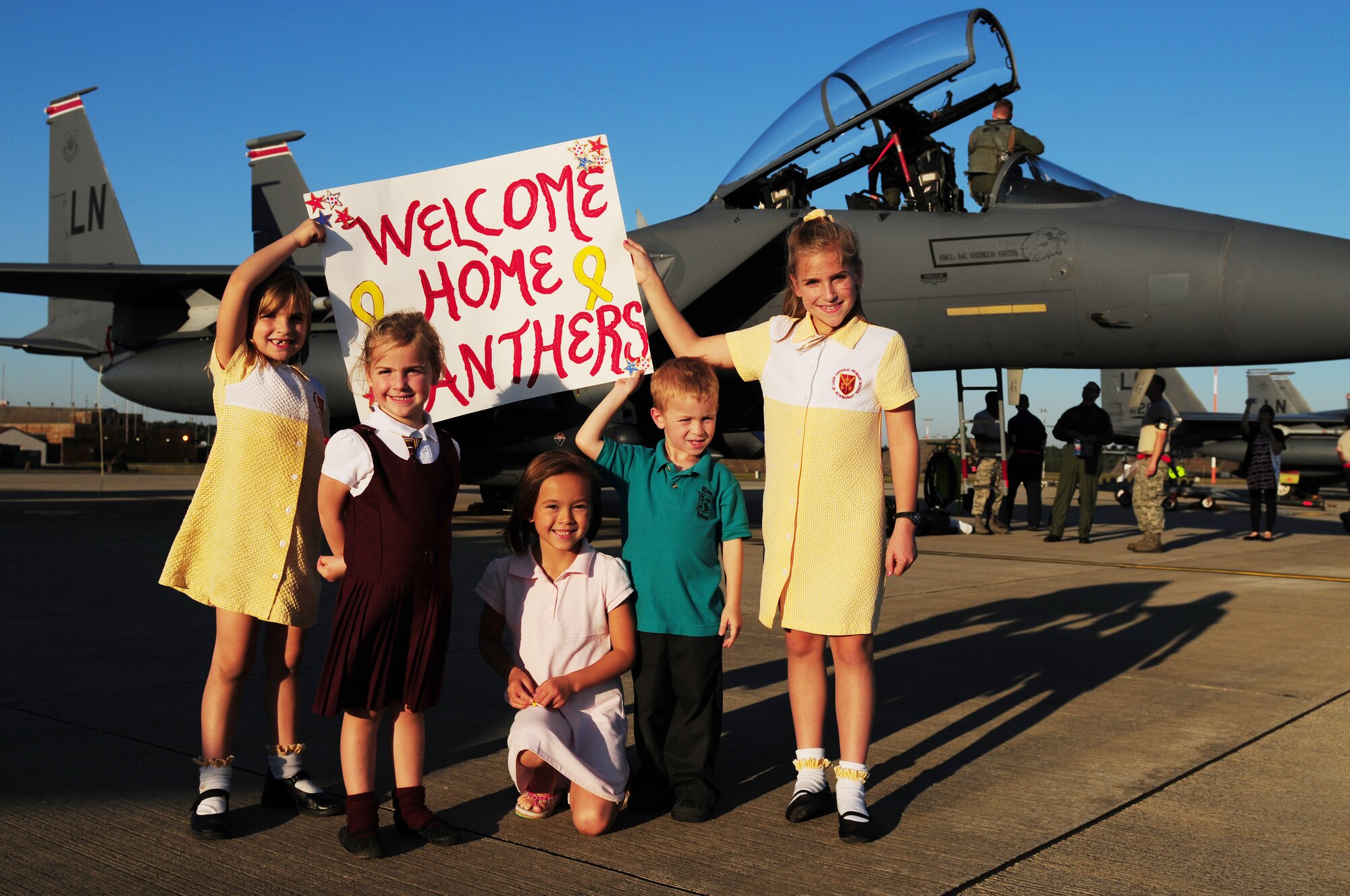 ROYAL AIR FORCE LAKENHEATH, England ? Sisters Katie, Maddie and Josie Orchard, and friends, Hayley Heitmeyer and Will Principi, along with members of the 48th Fighter Wing, welcome home the ?Panthers? on Sept. 30, 2011. Airmen from the 494th Fighter Squadron returned from deployment to Kunsan Air Base, South Korea where they supported the 8th FW?s mission. (U.S. Air Force photo by Senior Airman Lausanne Morgan)