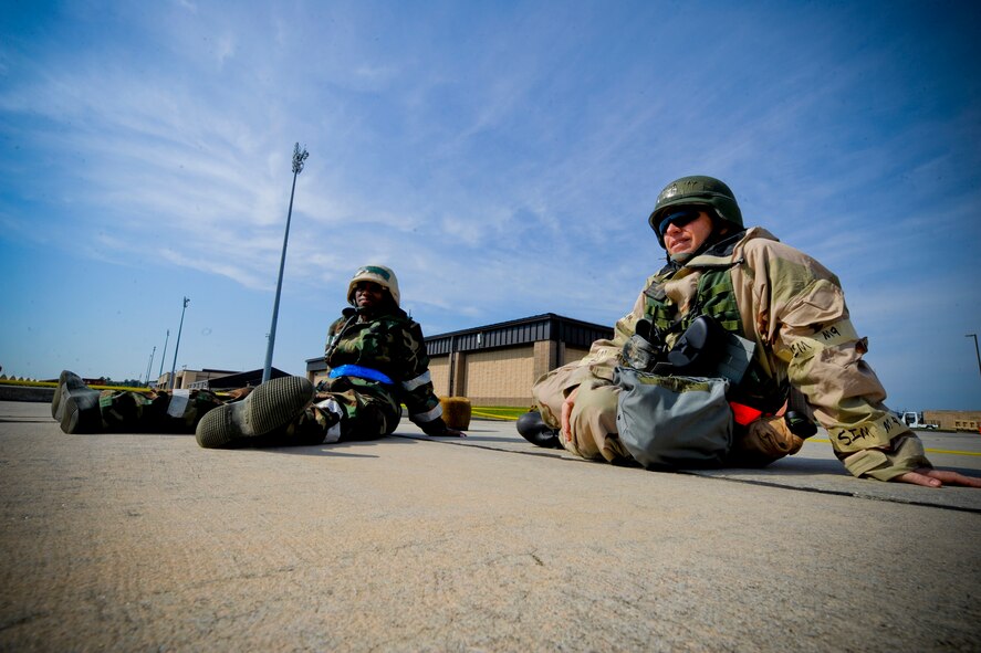 U.S. Air Force Senior Airman Erica Mitchell, 23rd Wing chaplain assistant, right, and Chaplain (Capt.) Tony King, also with the 23rd Wing, sit in a simulated bunker while in alarm condition during a phase II operational readiness exercise at Moody Air Force Base, Ga., Sept. 28, 2011. Depending on the alarm status, personnel outside reported to bunkers to ensure their safety and kept in contact with their unit control center to ensure 100 percent accountability. (U.S. Air Force photo by Staff Sgt. Joshua J. Garcia/Released) 