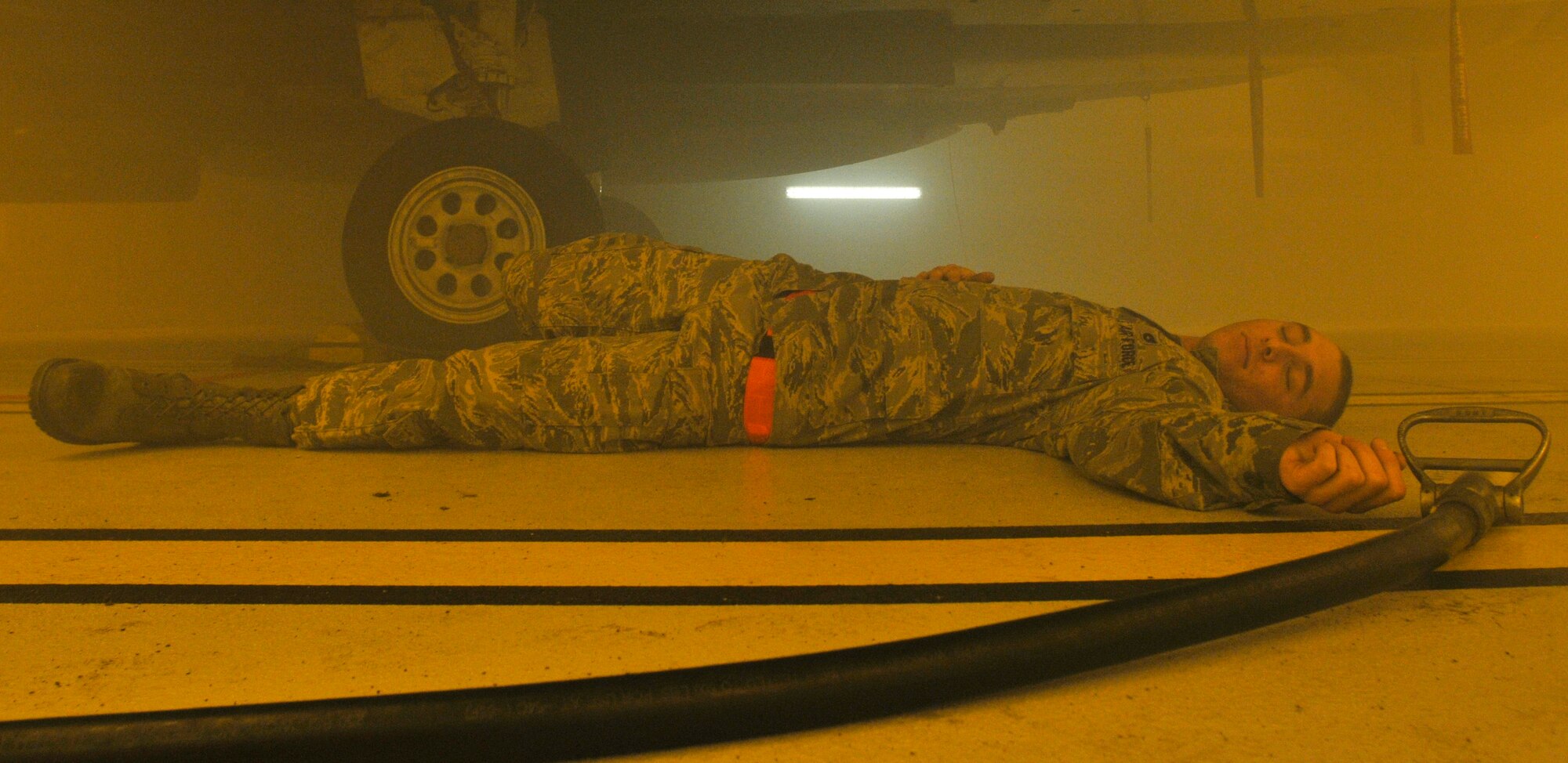 ROYAL AIR FORCE LAKENHEATH, England - Airman 1st Class Michael Koehler, 48th Aircraft Maintenance Squadron weapons load crew member, poses as a victim during exercise for the 48th Civil Engineer Squadron firefighters, Sept. 27, 2011. The 48th CES firefighters train routinely to remain proficient and ready to respond to emergencies. (U.S. Air Force photo by Senior Airman Tiffany M. Deuel)
