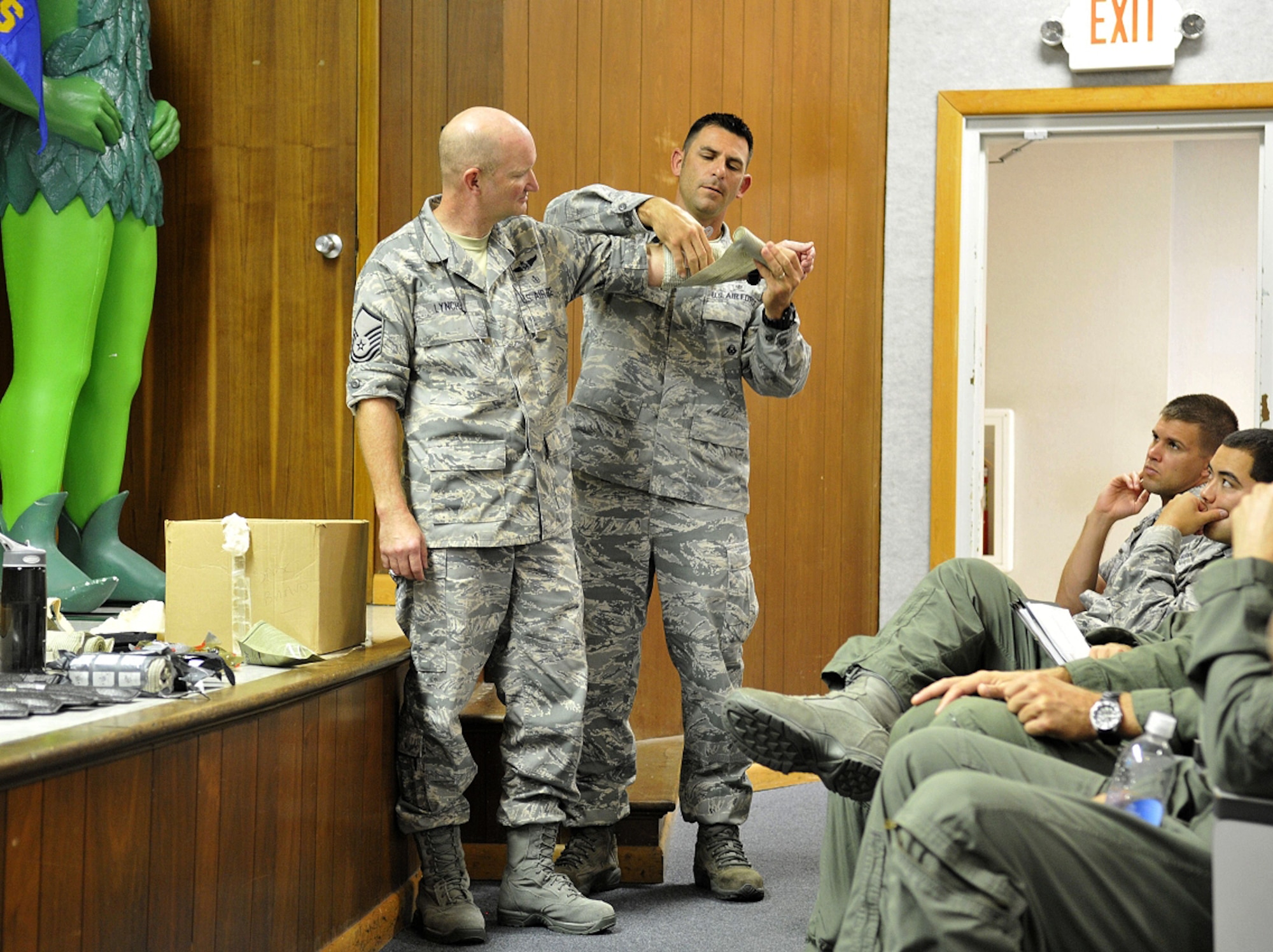 PATRICK AIR FORCE BASE, Fla. - 920th Rescue Wing Reservists Master Sgts Randy Lynch and Robert Carcieri, Combat Search and Rescue Medical Element instructors (CSARME)  instruct  helicopter aircrew on proper bandaging techniques during their pre-deployment briefings. The CSARME instructors here are busy with the high tempo of Rescue Airmen deployments; they are responsible for all medical training prior to a deployment. (U.S. Air Force photo/ Master Sgt. John Schiller)