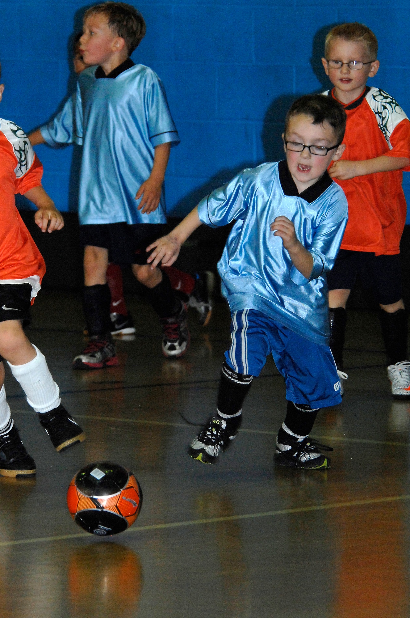 ROYAL AIR FORCE LAKENHEATH, England - Aidan Laksbergs, 6, son of Staff Sgt. Nick Laksbergs 95 Reconnaissance Squadron aerospace propulsion craftsman, sprints for the ball during a youth soccer league game Sept. 27, 2011.  The game featured youth from both RAFs Mildenhall and Lakenheath?s youth sports program and ended in a 3-3 tie. The indoor soccer league runs from Sept. 20 to Nov. 11 and is open to all ages.  For more information call 226-3180.  (U.S. Air Force photo by Tech. Sgt. Lee A. Osberry Jr.)